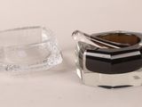 a glass ashtray and a glass ashtray on a table