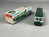 a toy bus that is sitting next to a box
