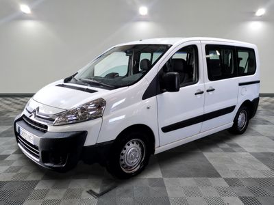 the white van is parked in a large room with a checkered floor