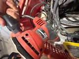 a man using a sander to polish a piece of wood