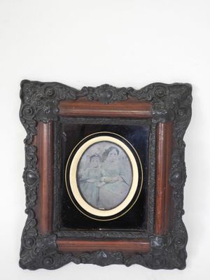 an old picture frame with a picture of a man and a woman on it