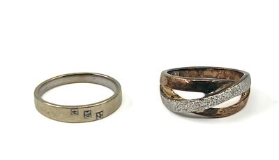 two rings with different designs on them sitting next to each other