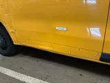 a yellow van that is parked in a parking lot