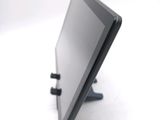 a tablet computer sitting on a stand on a white surface
