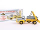 a toy truck with a crane on it next to a boxed box