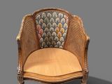 an image of a wicker chair with a cushion on top of it