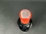 a close up of a metal sink with a red knob