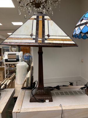 two lamps that are sitting on a table in a room
