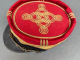 a red hat with a gold design on it