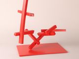 red sculpture of a tree made out of blocks on top of a red base