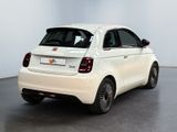 the small white car is parked in the large white room