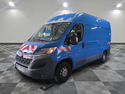 the blue van is parked on a checkered floor in the garage