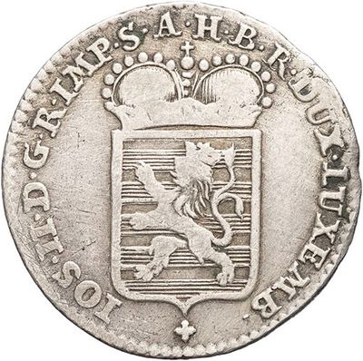 a close up of a coin with a coat of arms on it