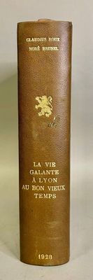 an old book sitting on top of a table next to a white wall
