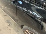 a black car that is parked on the side of the street