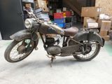 a old motorcycle that is parked in a garage