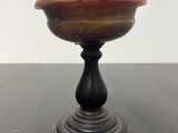a close up of a wooden bowl on a black table