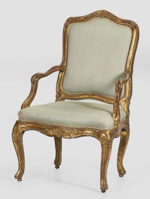 a gold and green upholstered chair with a beige upholstered seat