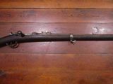an old gun on a wooden floor with a wooden floor