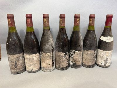 six bottles of wine are lined up in a row on a table