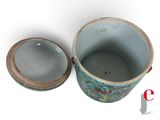 a blue vase with a lid sitting on a white surface