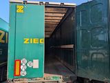 two green cargo trucks that are parked next to each other