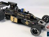 a black and gold race car with a flag on it