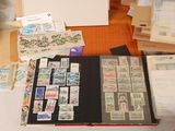 a lot of stamps on a table with a red pen