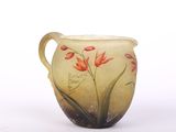vase with red flowers painted on it sitting on a white surface