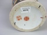 a cup with a design on it sitting on a table