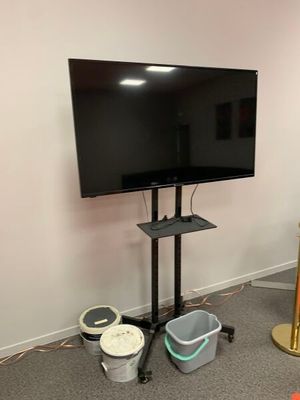 a flat screen tv on a stand in the corner of a room