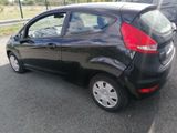 a black car that is parked in a parking lot