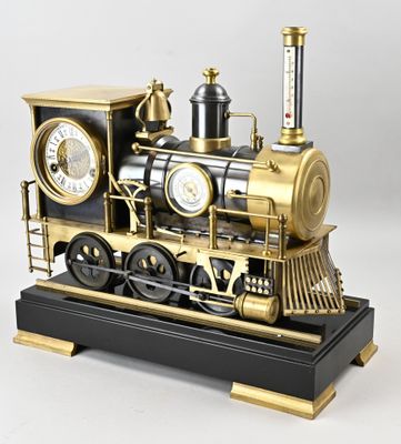 a black and gold model of a train on display