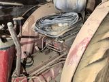 an old tractor that is sitting in a garage