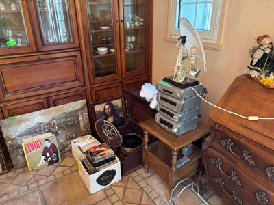 une pièce avec une commode, une armoire et d'autres objets posés par terre