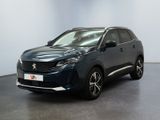 un SUV bleu foncé garé dans une pièce aux murs blancs