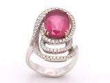 a close up of a ring with a pink stone and diamonds