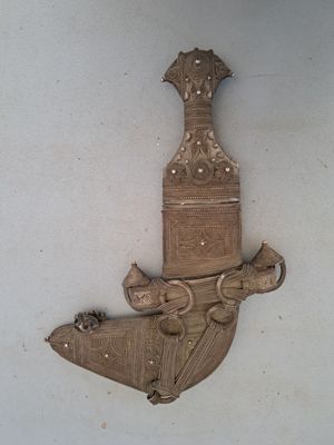 a wooden wall hanging with a clock and a bird on it