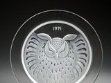 a glass plate with an owl on it on a stand
