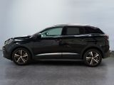 the black suv is parked in a large room with a white wall