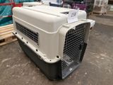 a white and black dog crate sitting in a warehouse