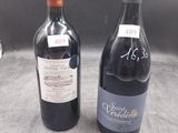 two bottles of wine sitting next to each other on a table
