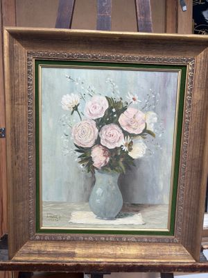 une peinture de fleurs dans un vase sur un chevalet