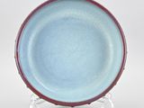 an image of a blue and red plate sitting on top of a table