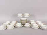 a lot of cups and saucers sitting on a table