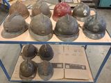 many helmets sitting on a cart in a warehouse