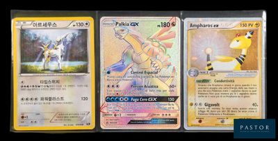 three pokemon cards sitting on top of each other on a table