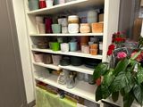 many pots and pans on the shelves in the kitchen