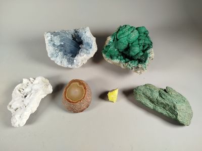 five different types of rocks on a white surface