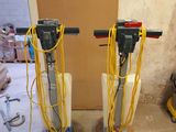 two machines that are sitting on the floor in the room